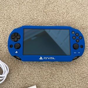 PS-VITA with case, charger, and manual.